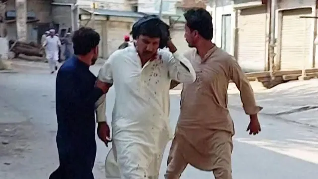 Car bomb and gun attack on mosque near police compound in Pakistan kills at least 16, officials say